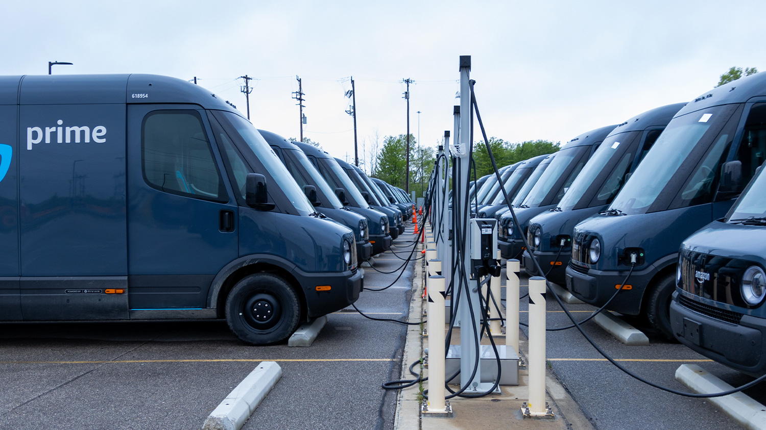 Amazon prime electric delivery vehicles charging at ev charging station